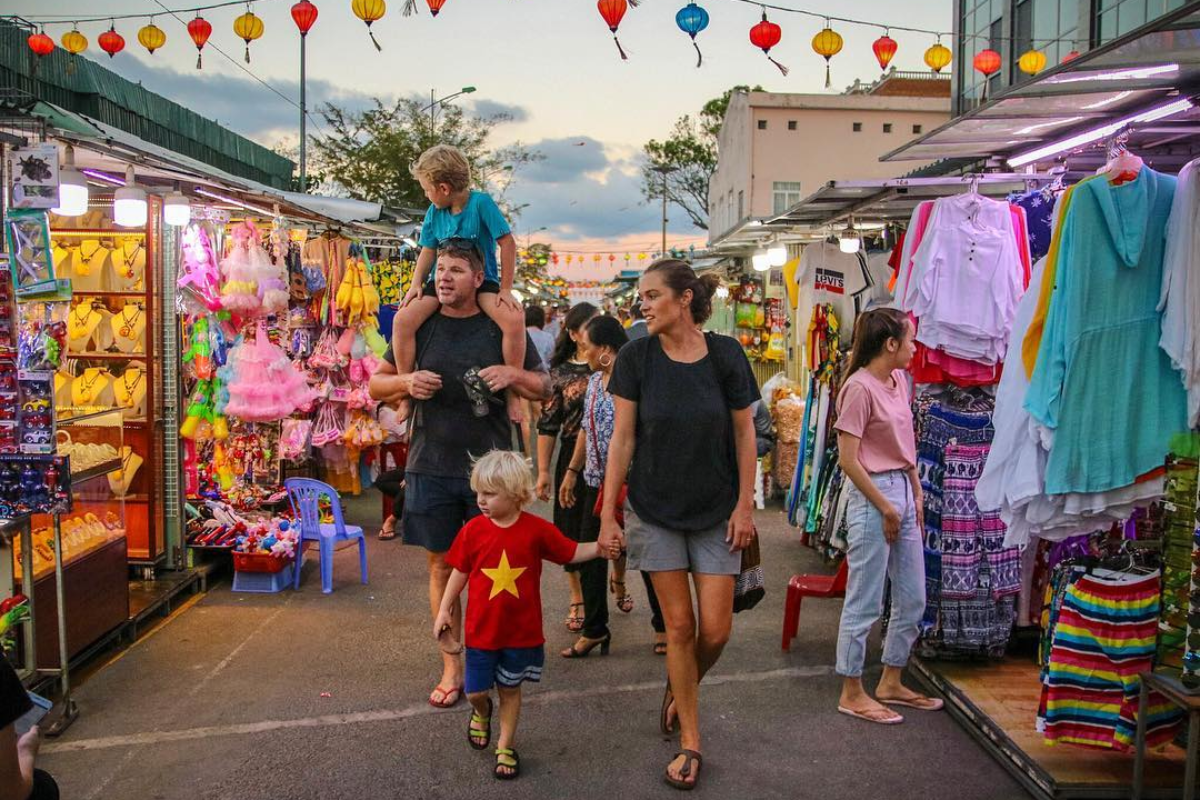 Family walking at night in Nha Trang Market